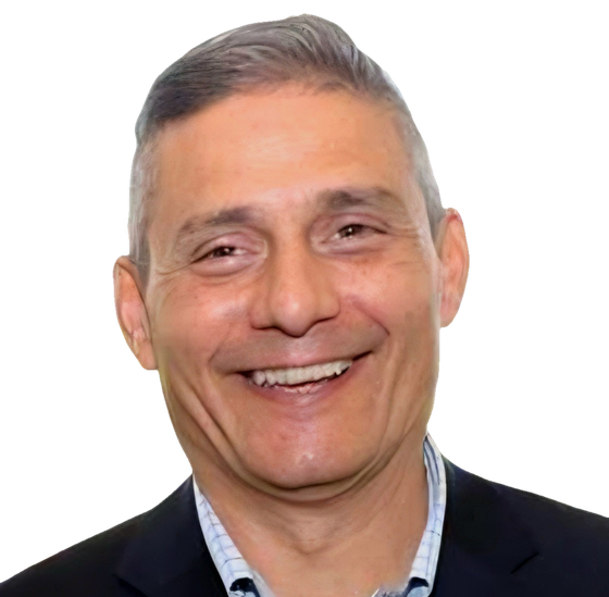 Anthony R. Siragusa, smiling, in a dark blazer and open-collared checked shirt.